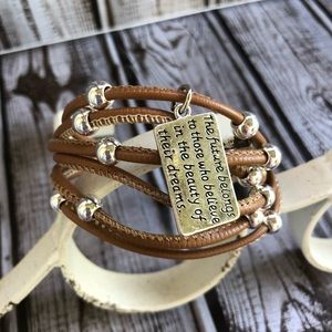 Faux leather bracelet with silver stamped charm.
